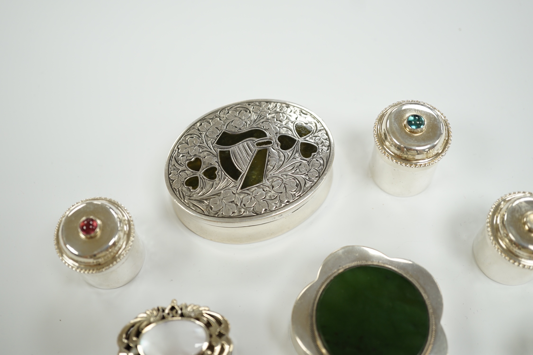 Nine assorted mainly modern silver or white metal and hardstone/cabochon set pill boxes, largest 59mm.